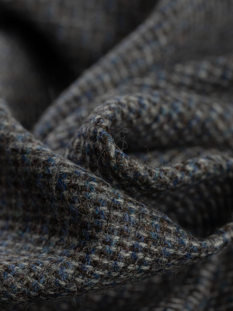 100% wool tweed pure wool fabric, reverse birdseye weave, blue, brown, grey yarns, mottled all over colour, woven with melange yarn, made in Huddersfield, made in Yorkshire. High quality twill weave wool fabric for clothing, jackets, dresses. buy fabric by the metre