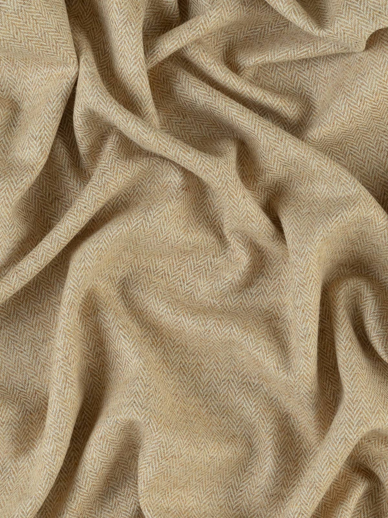 Twisted aerial view of Yorkshire Tweed Herringbone in Grandma's Shortbread, capturing the full width of the fabric. The warm, creamy hues and classic herringbone chevrons unfold beautifully, reminiscent of the comforting textures of a cozy baking day in Grandma’s kitchen.