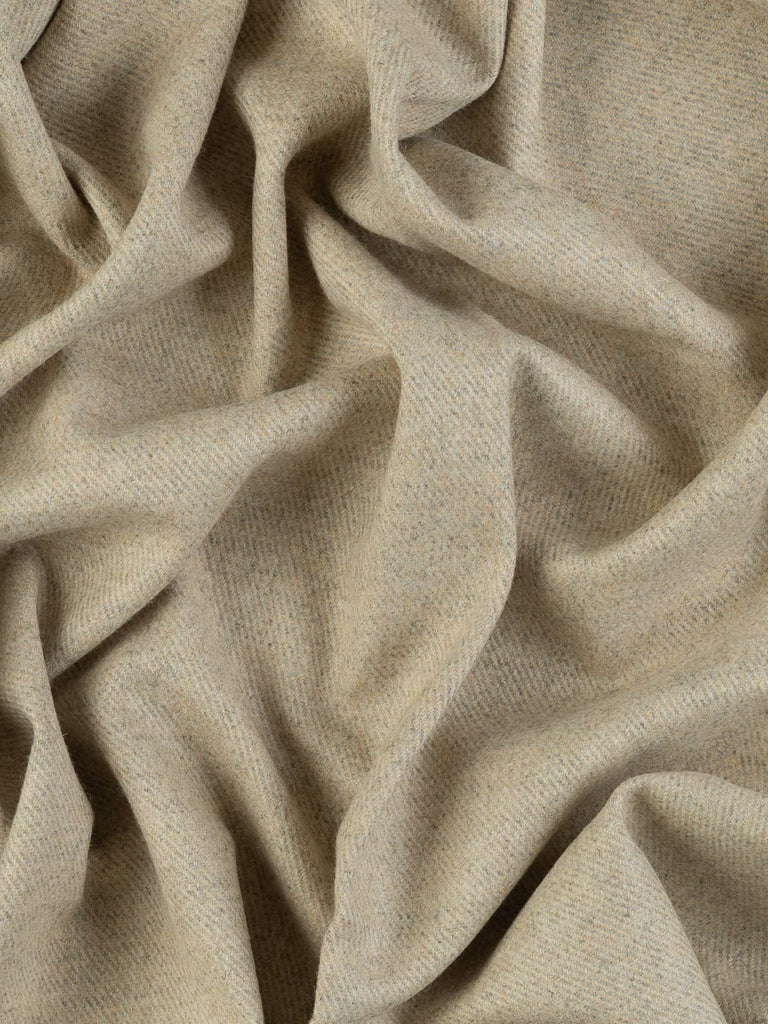 Aerial twist shot of the Crimson Vale wool fabric revealing its vibrant crimson shades, golden and blue flecks, and structured heavyweight twill surface.