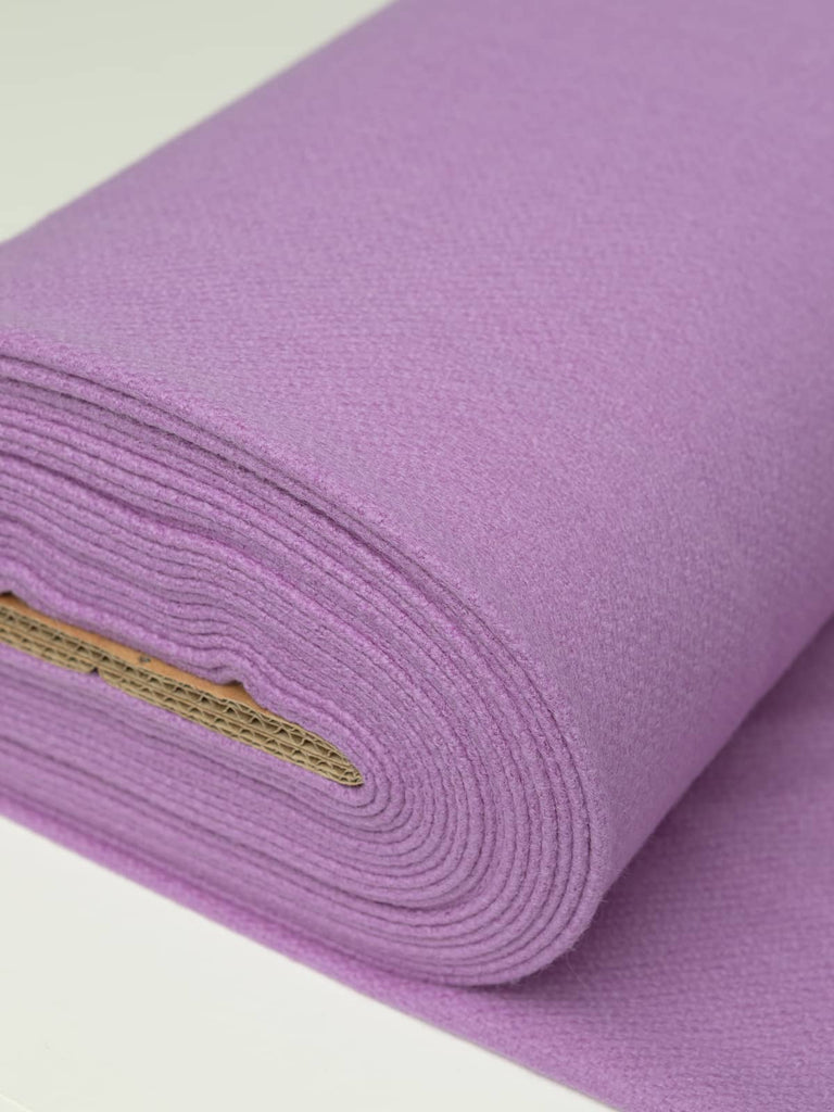Angled roll of Violet Cream Twill Melton wool, 600gsm, showing soft violet tone with blue-magenta undertones and dense, brushed felted finish