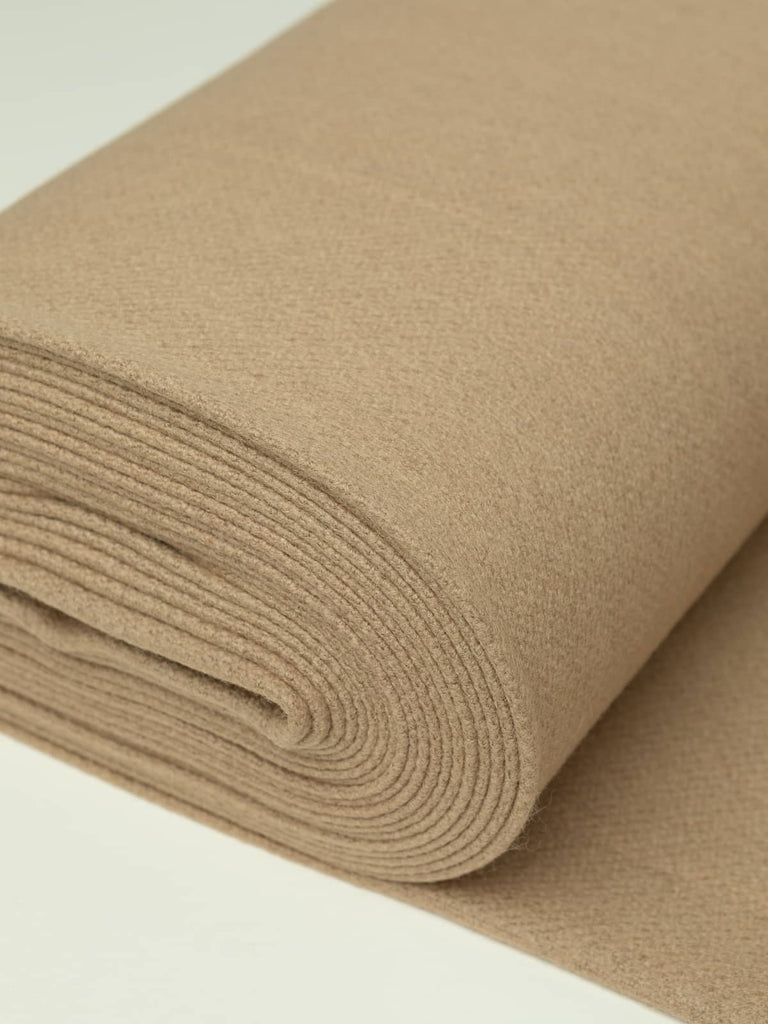 Angled roll of Vanilla Fudge Twill Melton wool, 600gsm, in warm golden caramel shade with dense felted finish and soft brushed surface