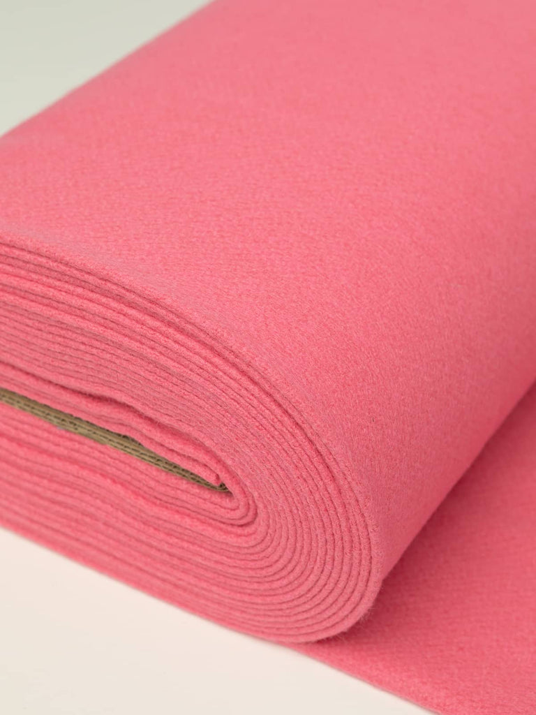 Angled roll of Rose Fondant Twill Melton wool, 600gsm, in confident sugared pink shade with dense felted finish and soft brushed surface