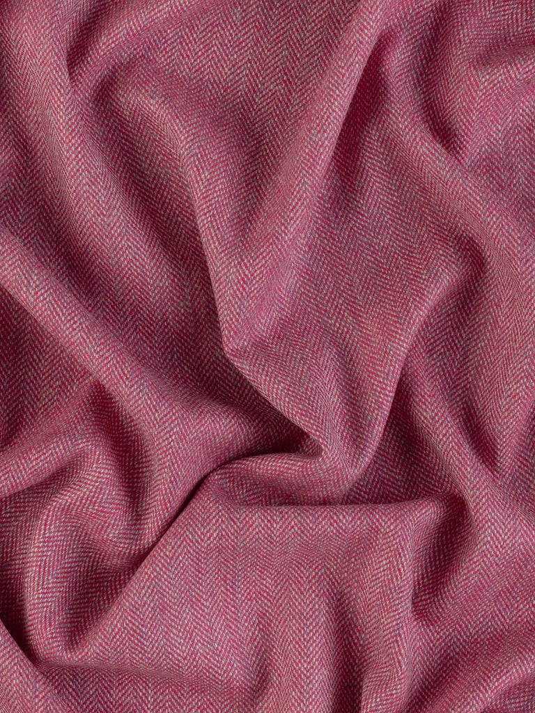 Aerial view of Eco Herringbone Yorkshire Tweed in Campion Crush, twisted to reveal the full width and herringbone pattern. The rich pink and misty lilac hues combine beautifully, showcasing the fabric’s dynamic and cheerful design.