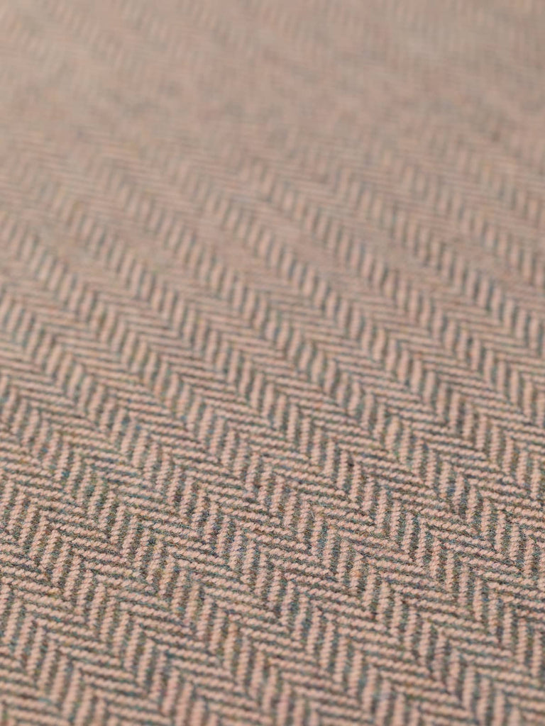 A detailed flat image of Nostalgic Blush, highlighting the intricate chevron pattern with delicate, soft pink accents. The fabric's color palette mixes grey, green, and warm brown undertones, creating an elegant, refined appearance reminiscent of vintage dressing tables and delicate antique cosmetics. The luxurious lambswool texture is visible, adding depth and richness to the fabric.