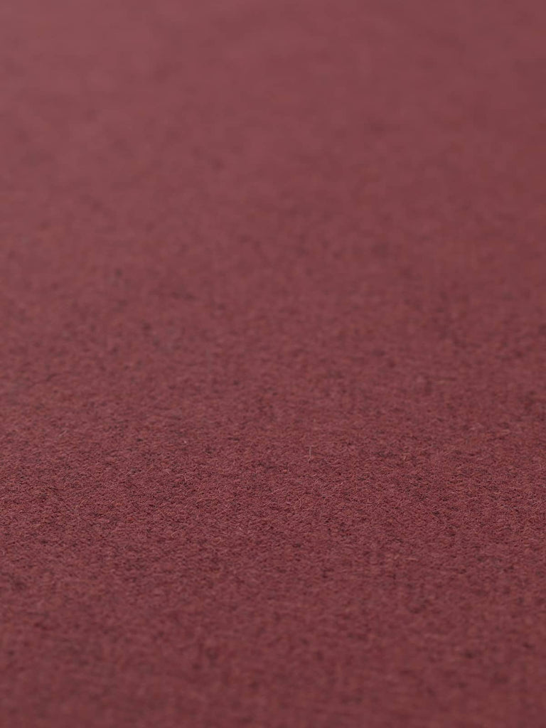 Angled flat view of Autumn Garnet lightweight lambswool herringbone fabric, 290gsm, displaying rich garnet-red chevron pattern over a textured marled grey base with soft, smooth surface finish