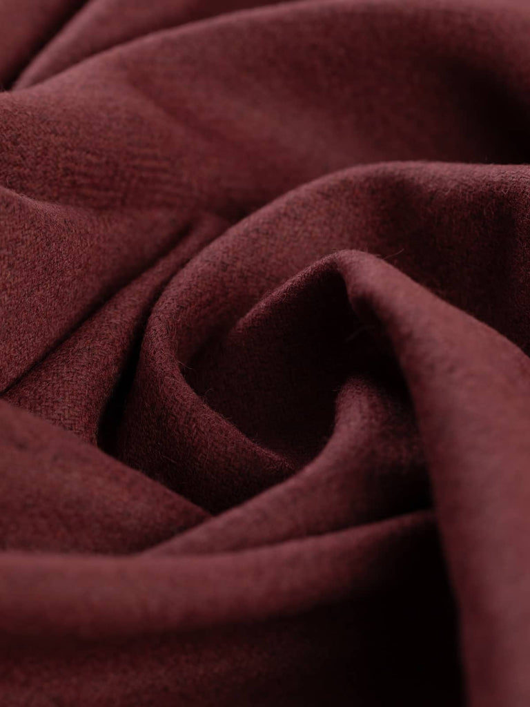 Twist of Autumn Garnet Marled Yorkshire Tweed Herringbone, 100% lambswool, 150cm wide, showing deep garnet-red tones with subtle marled grey undertones in a fine heritage herringbone weave