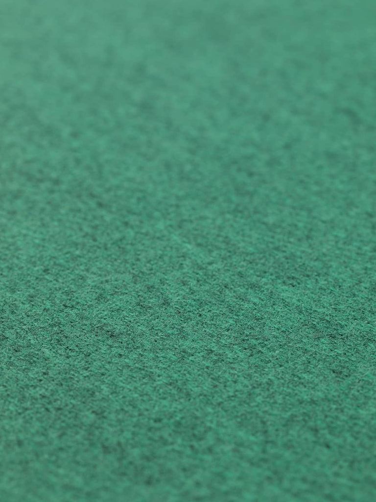 Angled flat view of Pineridge medium-weight Yorkshire herringbone fabric, 400gsm, featuring refined pine-blue green hues over a stone-grey melange base, tightly woven for structured tailoring