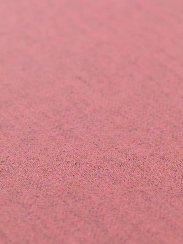 Angled flat view of Autumn Blush lighter-weight herringbone fabric, 150cm wide, featuring a subtle blush rose hue over a natural grey melange base, highlighting fine lambswool texture and smooth, supple drape
