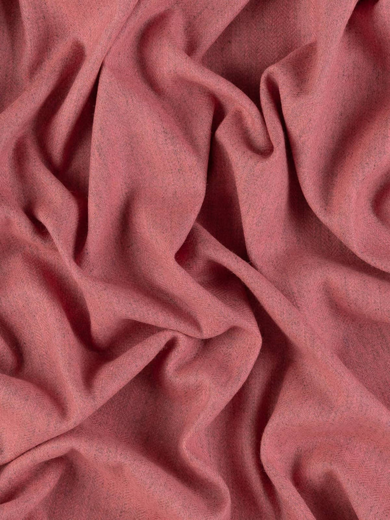 Overhead flat shot of Autumn Blush Marled Herringbone Tweed, capturing the gentle interplay of pastel pink and marled grey in a rhythmic chevron weave, evoking soft morning light and refined British tailoring