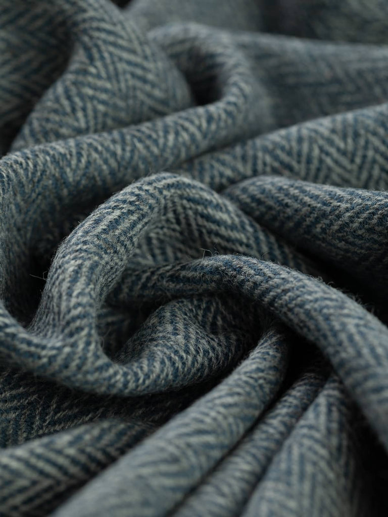 Twist of Twilight Quarry Yorkshire Wool Herringbone Tweed, 100% wool, 390gsm, featuring marled grey and inky blue-green chevrons inspired by dusk settling over quarry stone.