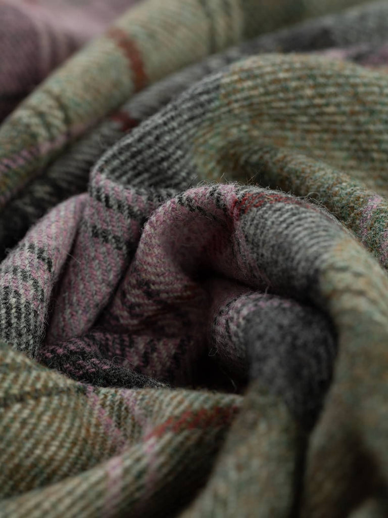Twist of Heathshore Mist Yorkshire Tweed plaid, 100% wool, 155cm wide, showing pinky lilac and sage green melange with grey, white accents, and signature Bloodline red overcheck