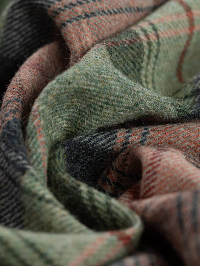 Twist of Heathland Blush Yorkshire Tweed plaid, 100% wool, 155cm wide, showing frosted heathland green, moody thunderstorm blue, coral blush accents, and bold Bloodline red overcheck