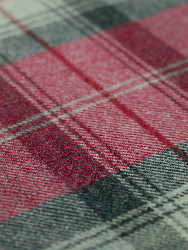 Angled flat view of Woodland Dusk Heritage Plaid, medium-weight wool tweed with 25cm x 27cm repeat, highlighting woodland-inspired palette of misty greys, teal-greens, deep forest tones, and warm berry red