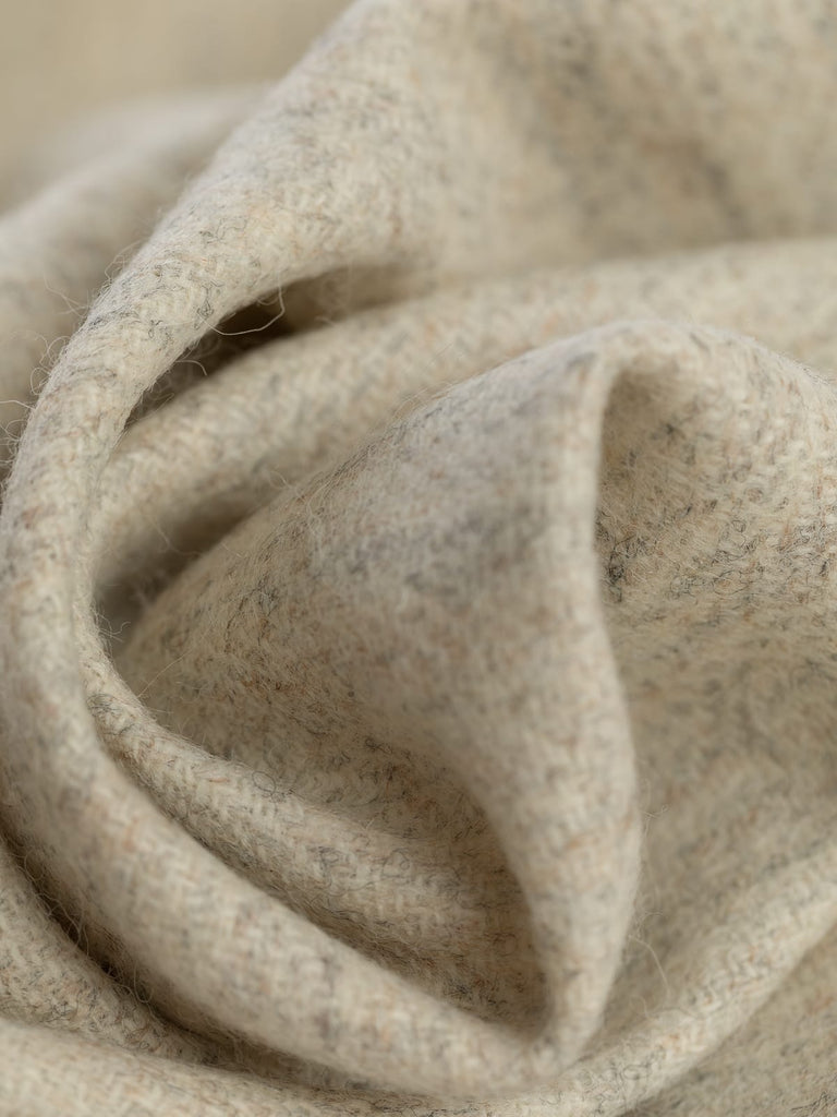 100% wool tweed pure wool fabric herringbone weave, marled cream beige all over tones, woven with melange yarn, made in Huddersfield, made in Yorkshire. High quality twill weave wool fabric for clothing, jackets, dresses. buy fabric by the metre