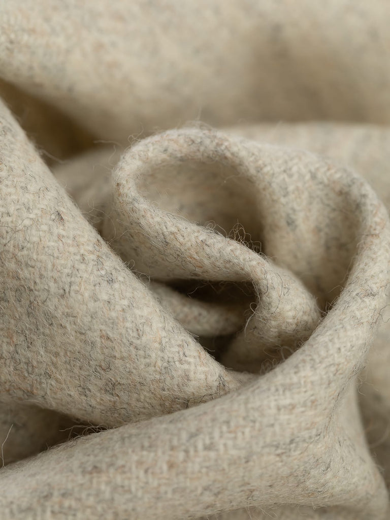 100% wool tweed pure wool fabric herringbone weave, marled cream beige all over tones, woven with melange yarn, made in Huddersfield, made in Yorkshire. High quality twill weave wool fabric for clothing, jackets, dresses. buy fabric by the metre