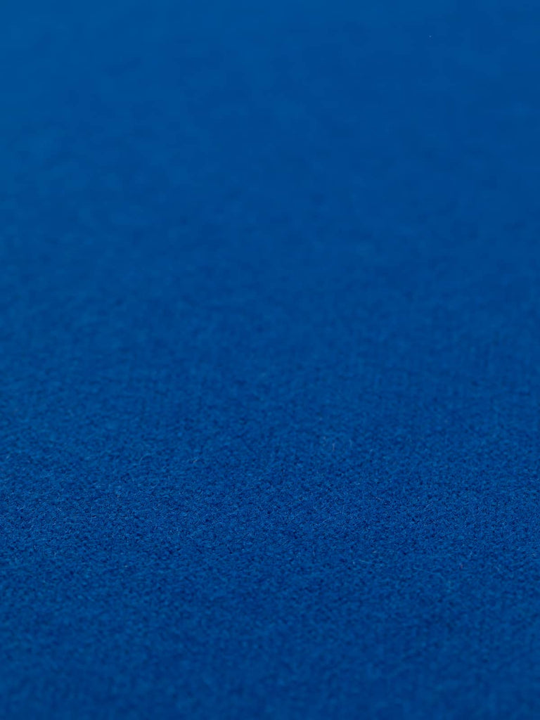 Flat angled view of Indigo Storm hopsack fabric, 130cm wide, displaying even hopsack weave structure and vibrant regal blue hue ideal for outerwear and interiors
