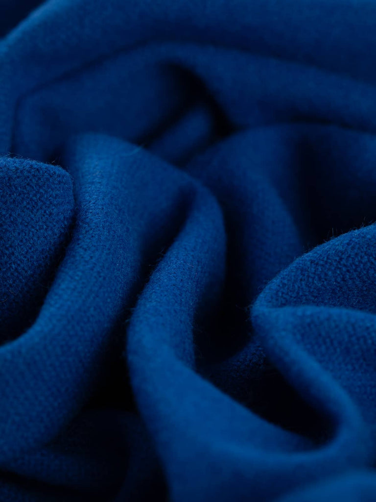 Twist of Indigo Storm 100% wool hopsack, highlighting cosy brushed texture, medium weight handle, and intense lightning-storm inspired indigo shade