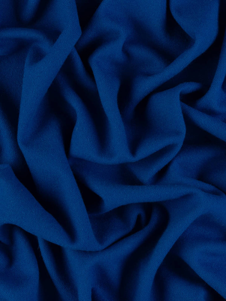 Twist of Indigo Storm 100% wool hopsack, highlighting cosy brushed texture, medium weight handle, and intense lightning-storm inspired indigo shade