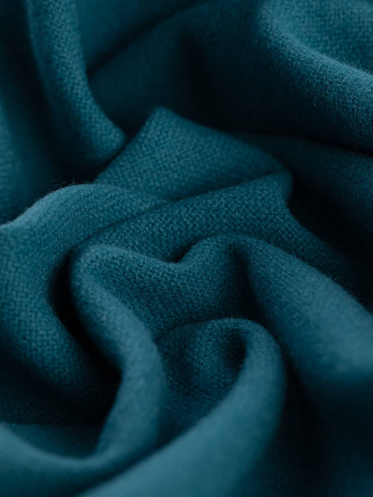 Twist of Atlantic Depth 100% wool hopsack, highlighting cosy brushed texture, medium weight handle, and jewel-toned ocean-inspired blue-green shade