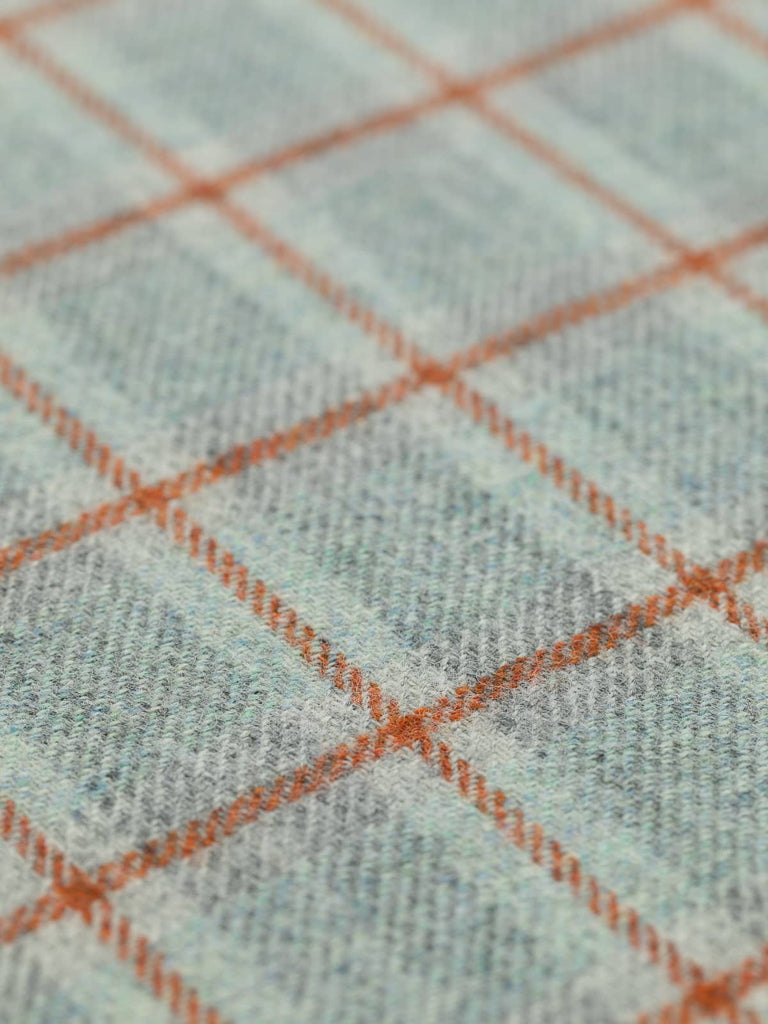 Angled flat view of First Light Heritage Check, medium-weight wool with subtle wider band beneath the windowpane, highlighting frost-inspired blue-grey tones and warm cedarwood accent