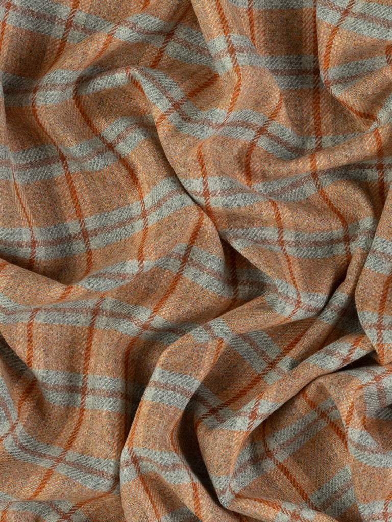 Overhead flat shot of Ember View Yorkshire woollen windowpane check, capturing marled grey foundation, fiery sunset-orange melange squares, and red-hued Cedarwood overcheck across textured wool surface