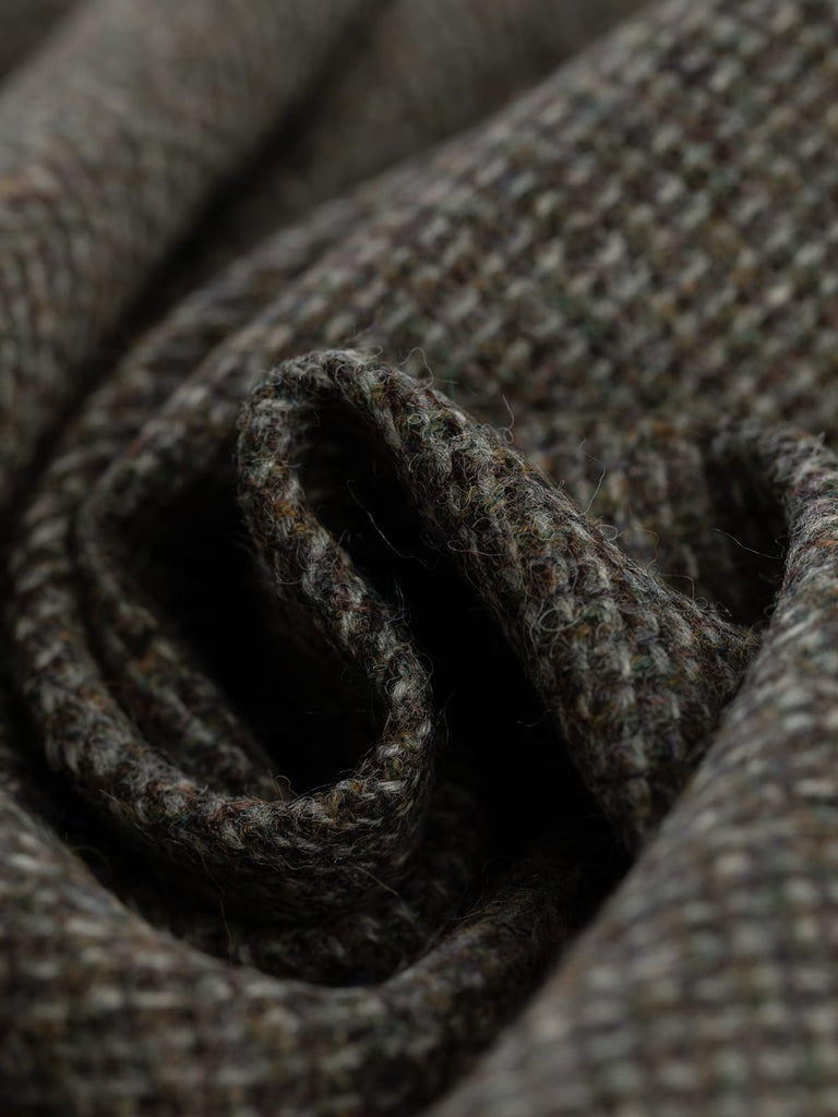 100% wool tweed pure wool fabric, reverse birdseye weave, green, khaki, purple, brown, grey yarns, mottled all over colour, woven with melange yarn, made in Huddersfield, made in Yorkshire. High quality twill weave wool fabric for clothing, jackets, dresses. buy fabric by the metre
