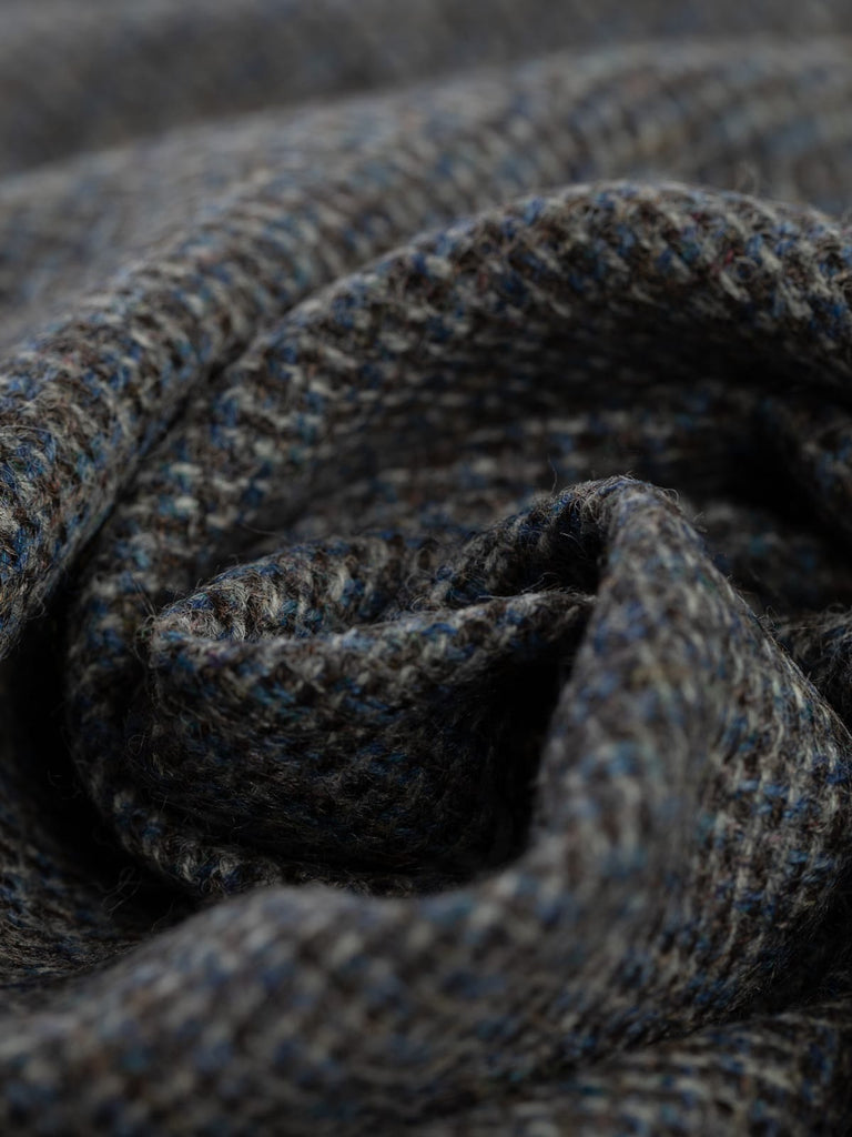 100% wool tweed pure wool fabric, reverse birdseye weave, blue, brown, grey yarns, mottled all over colour, woven with melange yarn, made in Huddersfield, made in Yorkshire. High quality twill weave wool fabric for clothing, jackets, dresses. buy fabric by the metre