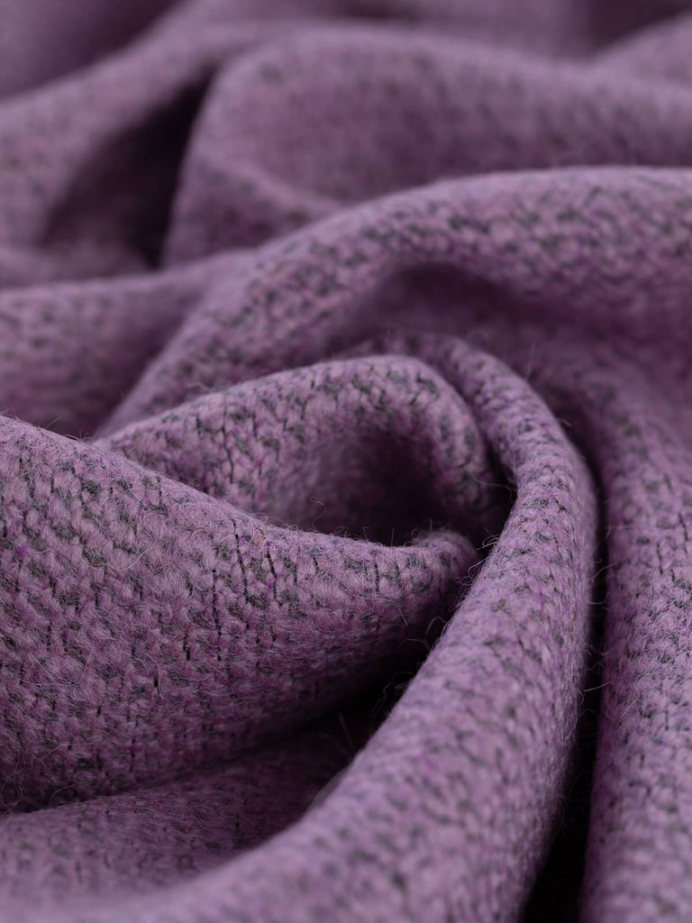 Twist of Crystal Amethyst Yorkshire Wool Bouclé Tweed, 100% wool, 470gsm, in soft lilac and charcoal melange tones, showing its subtly textured herringbone weave and slubby boucle yarns.