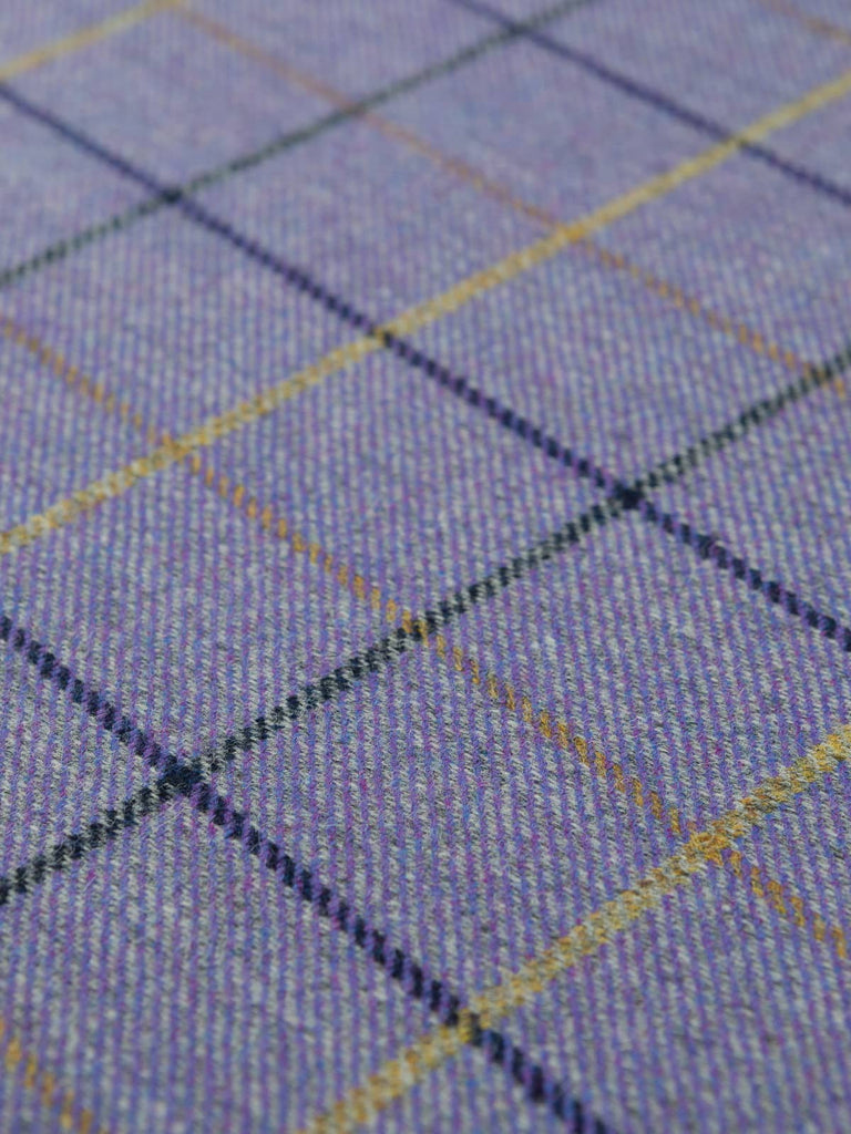 Angles flat shot of Winter Pansies tweed, highlighting the soft purple weft, grey marl warp, crisp navy structure, and delicate gold lines across the windowpane pattern.