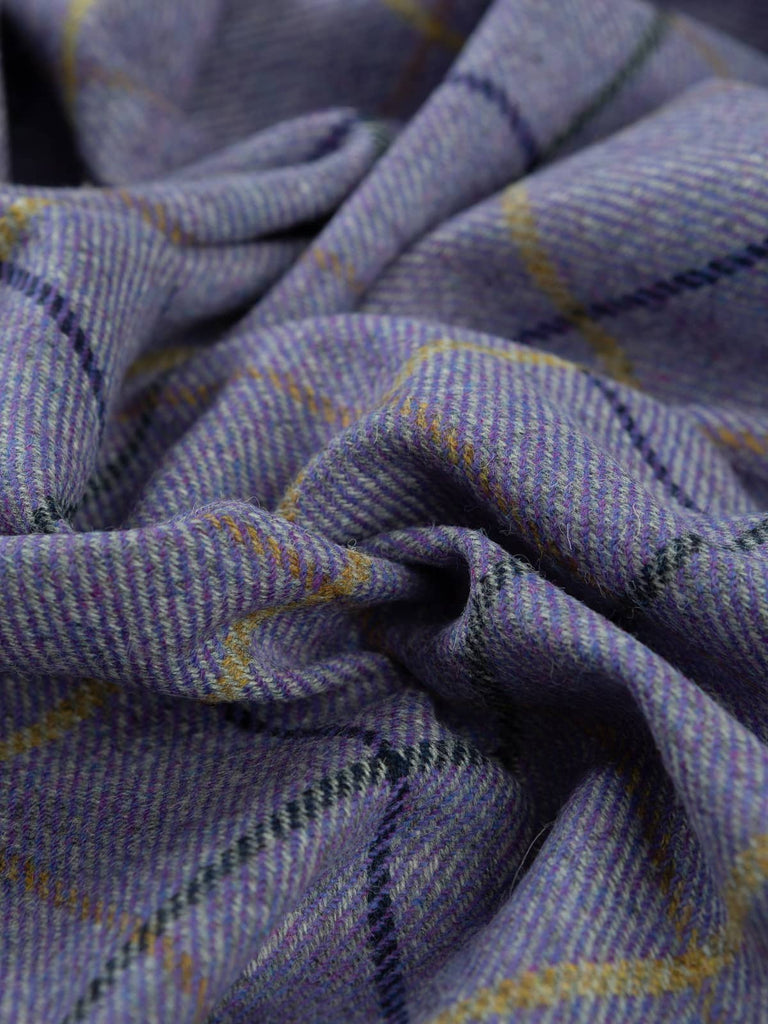 Aerial twist shot of the Winter Pansies fabric, capturing twisted folds from above and emphasising the frosted-petal purple tones, grey marl, navy shadows, and gold highlights.