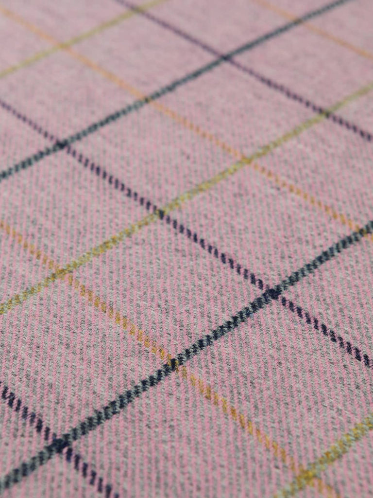 Angles flat shot of Dusk Bloom tweed, displaying its refined windowpane pattern, grey–pink marled base, and crisp navy and golden-green checks in clear, even alignment.