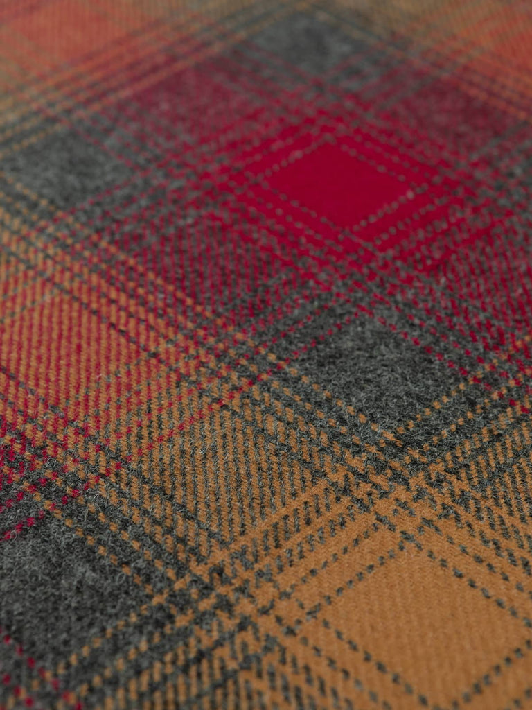 Angles flat shot of Fireside Glen Check wool tweed, highlighting its classic glen plaid layout, layered fireside hues and softly brushed, structured texture.