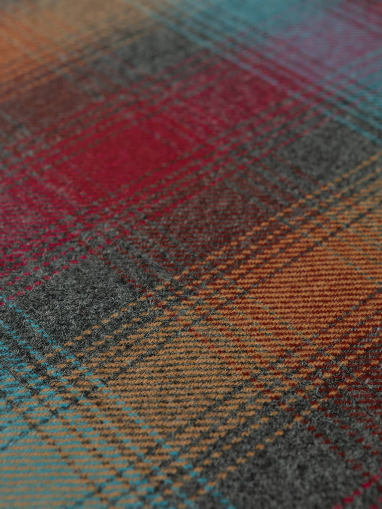 Angles flat shot of Jewel Glen Check wool tweed, highlighting its classic glen plaid layout, jewel-tone accents and softly brushed, structured wool texture.
