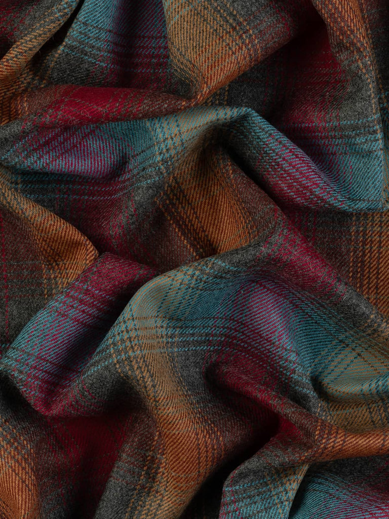 Aerial twist shot of Jewel Glen Check tweed, capturing the twisted fabric from above to reveal layered melange tones and shimmering gem-inspired colour intersections.