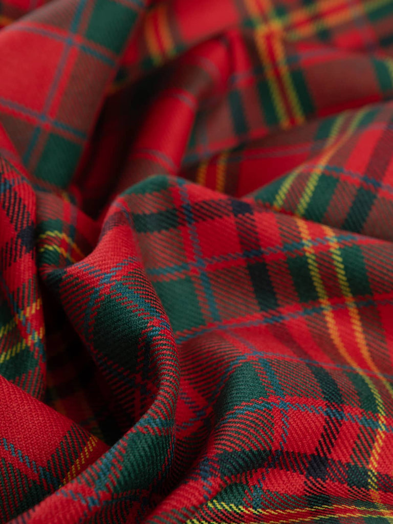 Twisted shot of MacAlister Modern Tartan showcasing soft, medium-weight wool twill texture with rich Highland red and forest green tones accented by gold lines.