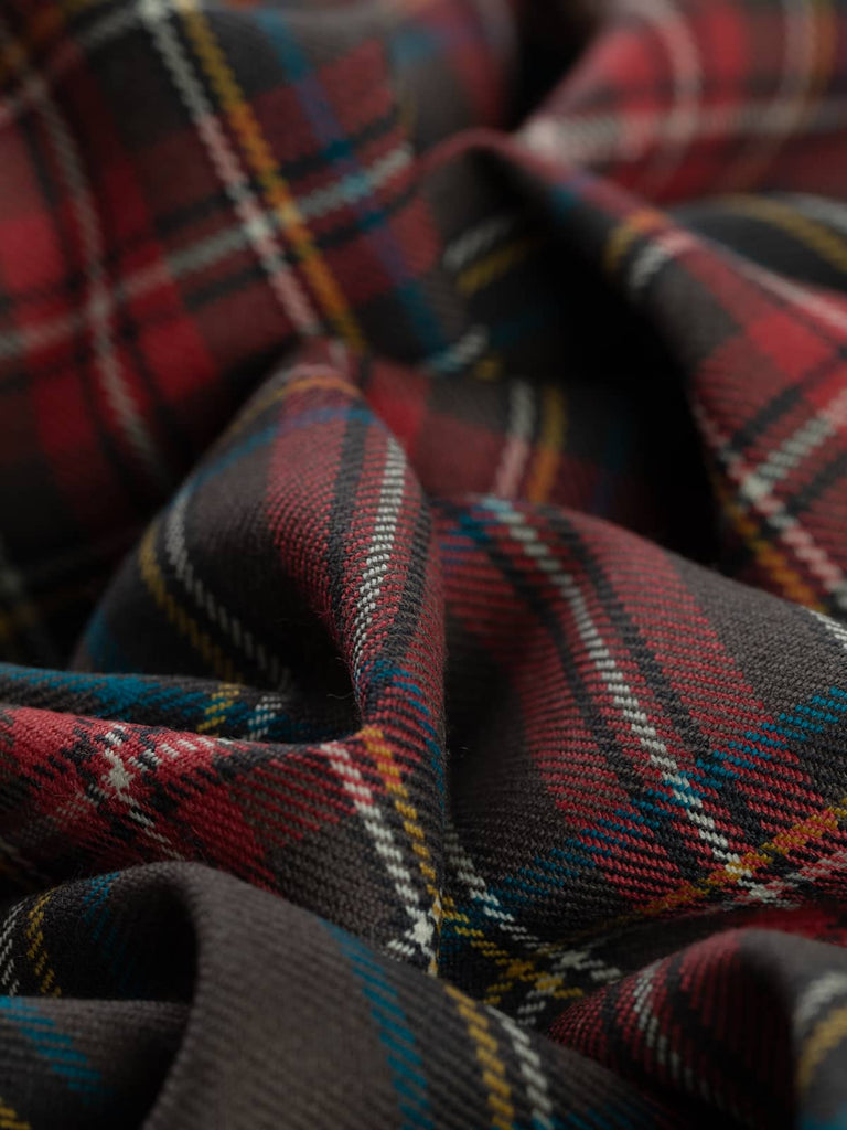 Twist of Princess Mary Muted Tartan 100% wool fabric, showing soft drape, twill texture, and muted multicoloured heritage check pattern