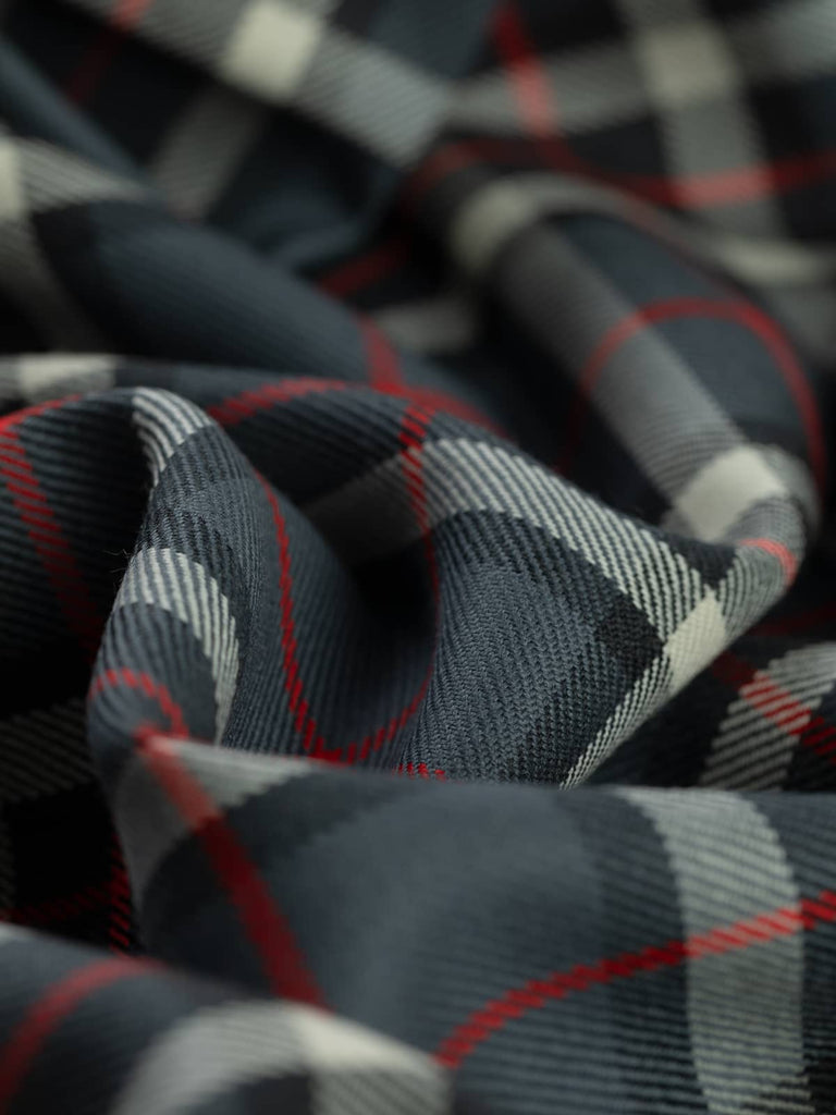 Twist of Thompson Grey tartan 100% wool fabric, showing soft drape, twill weave, and refined check pattern rooted in Scottish heritage
