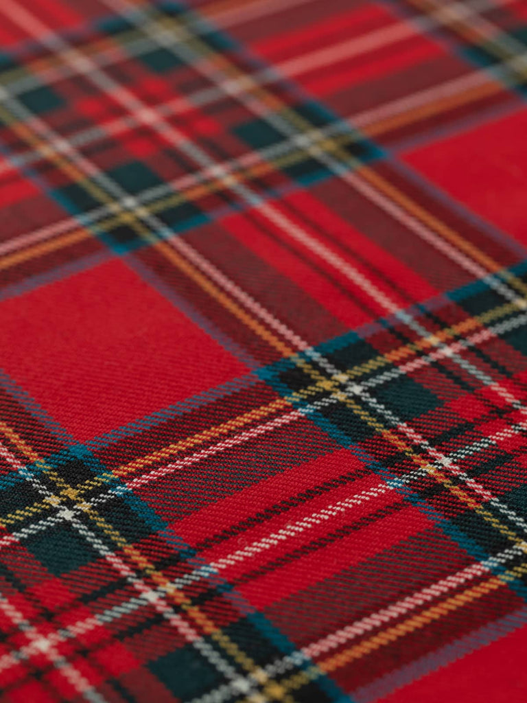Flat angled view of Royal Stewart tartan fabric, 11.5cm x 14cm repeat, displaying bright red ground with symmetrical green, blue, yellow, black, and white check pattern