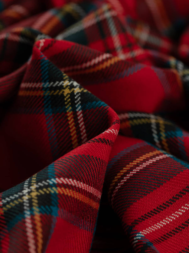Twist of Royal Stewart tartan 100% wool worsted, highlighting soft drape, twill weave texture, and vibrant multicoloured sett rooted in royal heritage and punk fashion