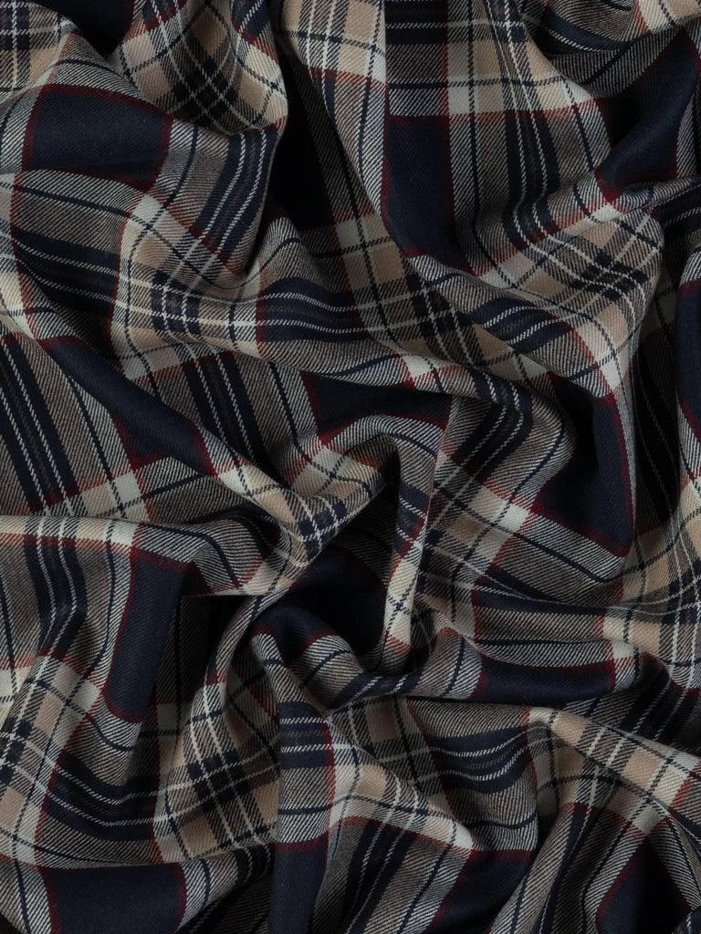 Twist of Stewart Navy tartan 100% wool worsted, highlighting twill weave texture, soft handle, and striking contrast between navy base and red, beige, and white accents