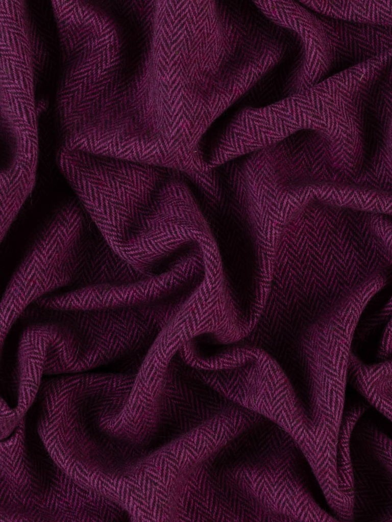 An aerial view captures the Berry Beautiful fabric's captivating blend of colors, with the vibrant magenta and plum yarns swirling together to create a luscious, berry-inspired texture that perfectly embodies the fabric's luxurious quality.