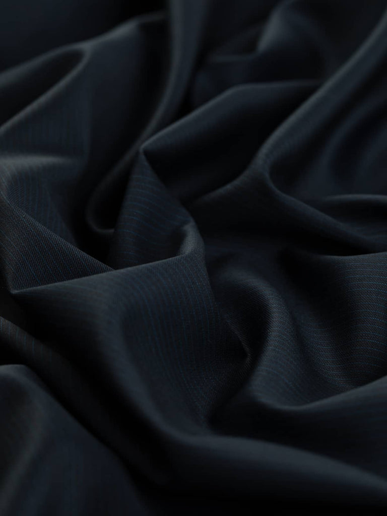 Detailed view highlighting the intricate pinstripe pattern woven into the navy worsted wool fabric, showing the classic and elegant design.