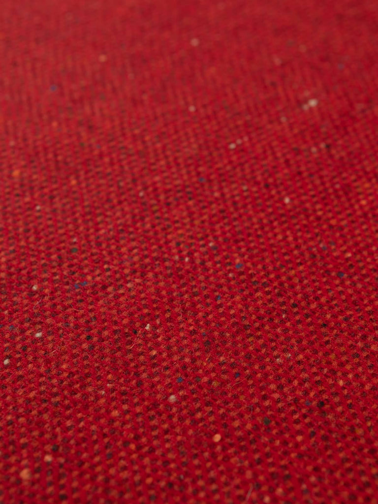 Flat overhead view of Ember Glow Lambswool Donegal Tweed, 162cm wide, capturing classic herringbone pattern, vibrant ember hues, and cosy, lightly felted surface.