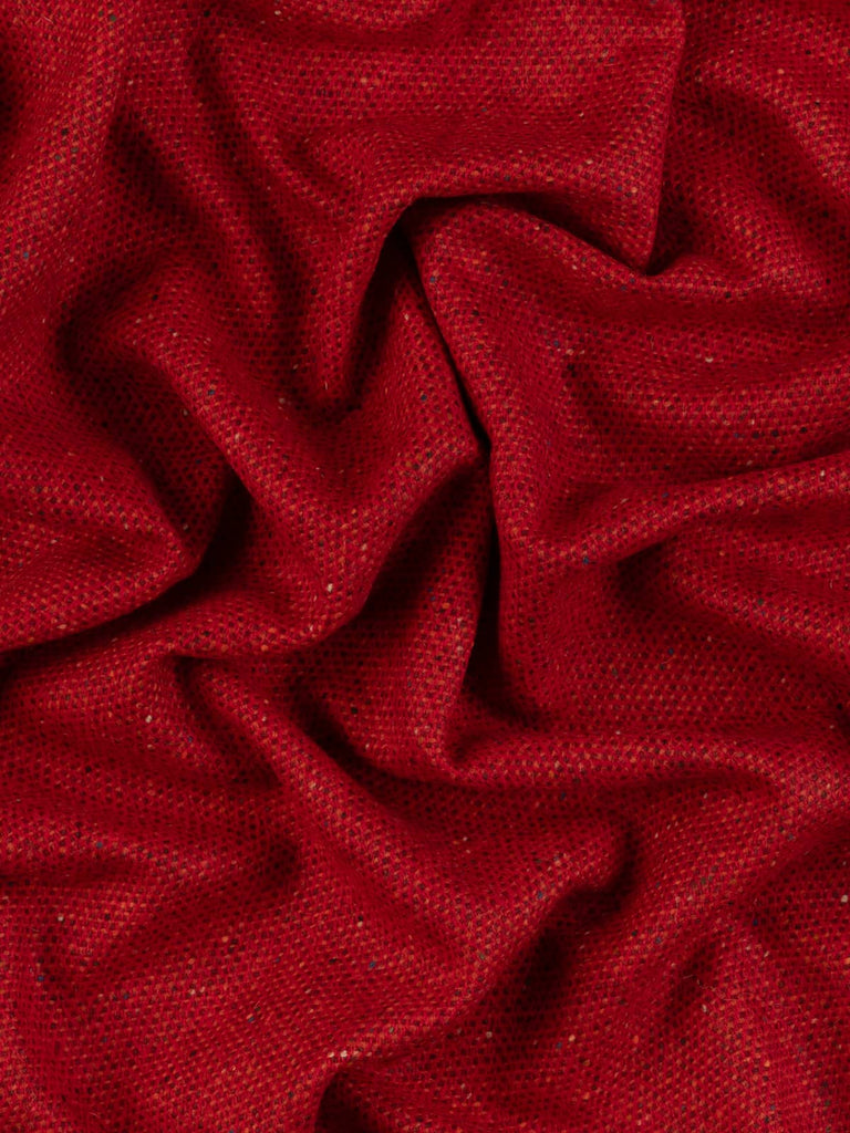 Twist of Ember Glow Donegal Tweed showing rich Pillar Box red, fire orange, and deep wine tones with signature flecked texture and soft brushed wool finish.