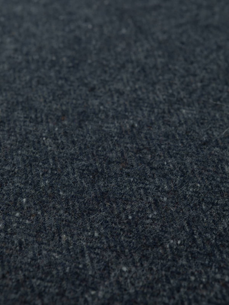 Overhead flat view of Slate Cascade Donegal Tweed, 160cm wide, capturing subtle herringbone pattern, slate-blue tones, and traditional flecked surface.