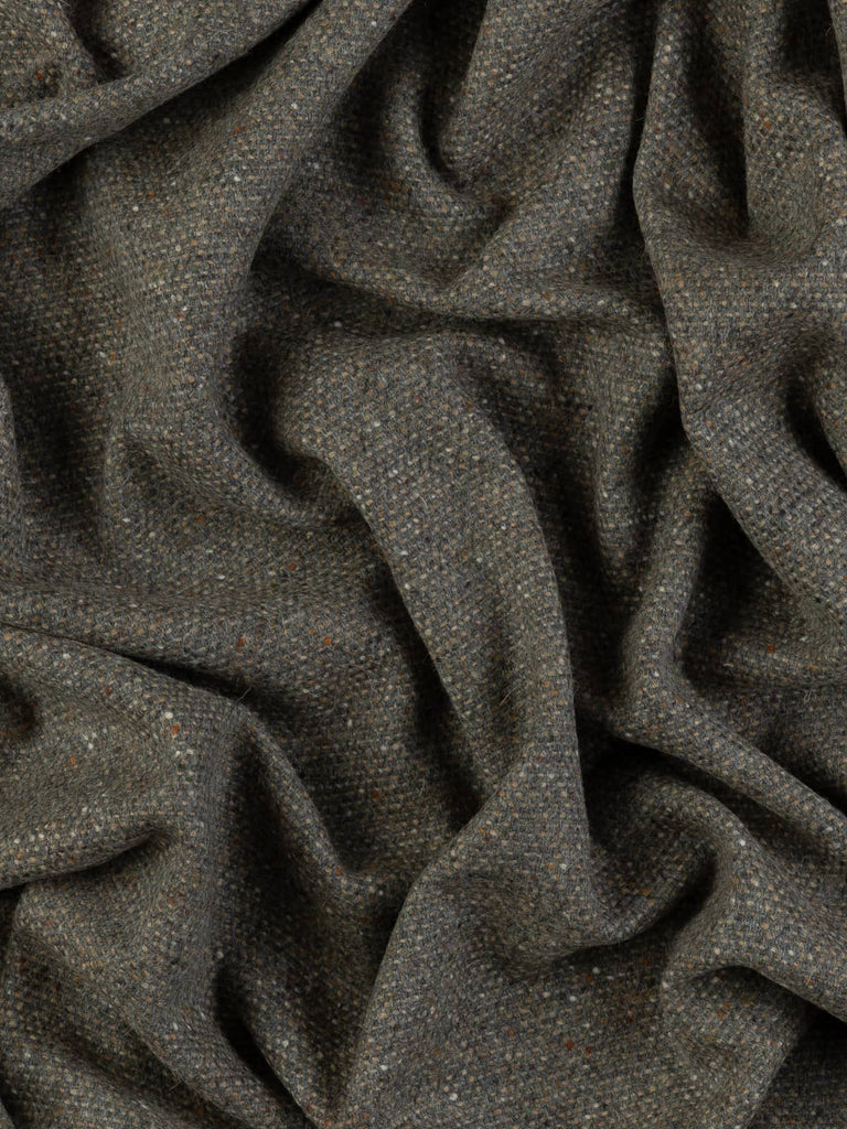Twist of Pebble Beach Tweed showing natural grey and brown herringbone weave with Donegal neps and a softly brushed lambswool texture.