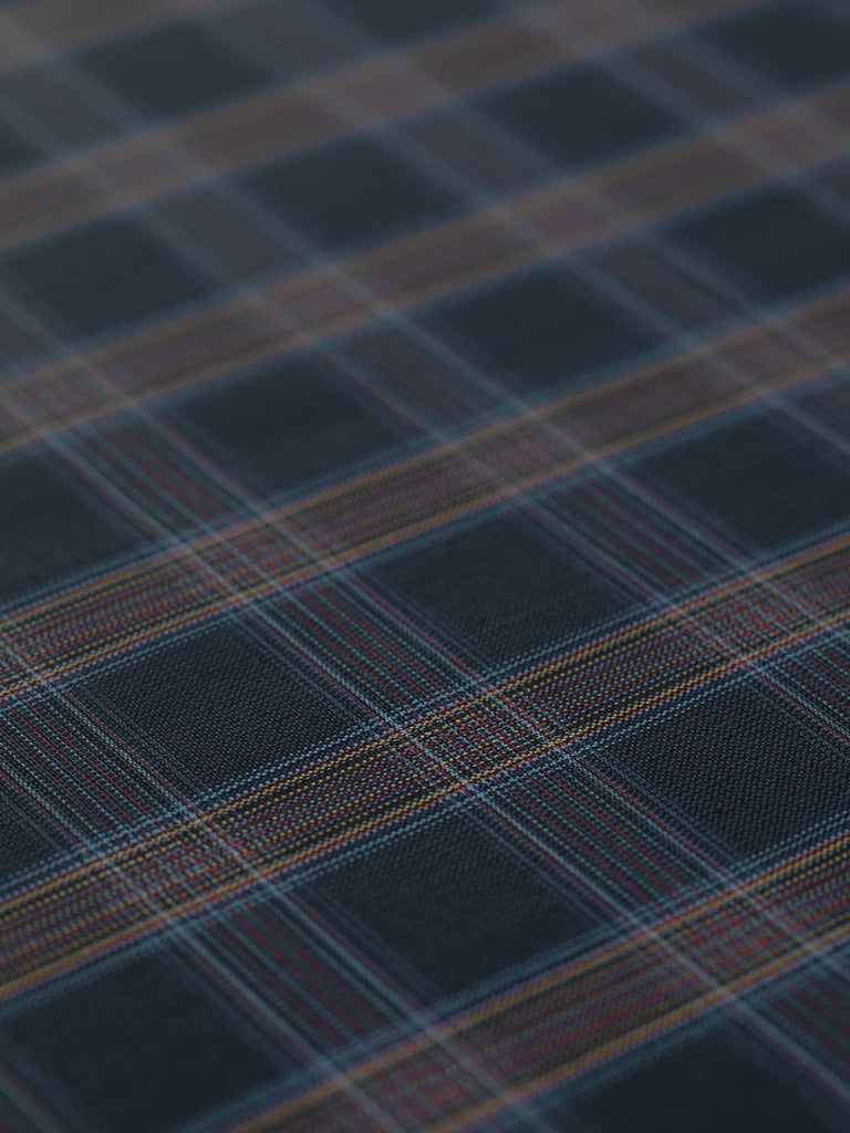 This exquisite Midnight Spectrum Check suiting fabric is made from 100% wool and boasts a closely woven, stable hand with a subtle sheen. The multi-hued windowpane check on a dark navy background adds refined style to garments like jackets, skirts, dresses, and trousers, perfect for office wear or smart casual outfits.