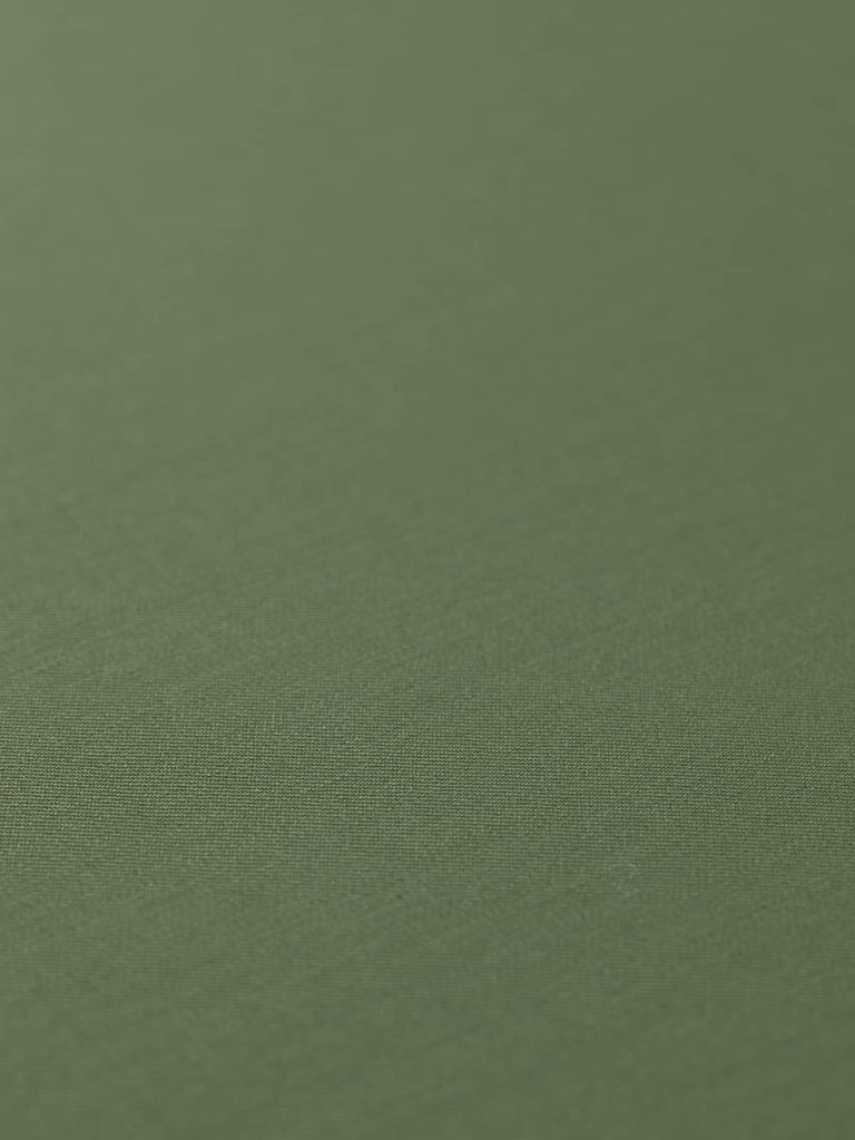 Flat, angled view of Desert Sand fabric laid out to showcase the even, fine twill weave and silky texture. The warm sand beige color, with faint grey undertones, makes it ideal for tailored garments or smart accessories with a minimalist, military-inspired edge.