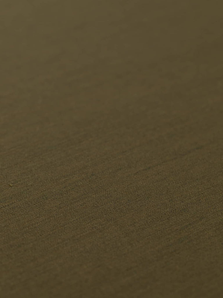 Flat, angled view of Dark Olive fabric, showcasing its luxurious, dense finish with a lustrous sheen. The finely woven wool-blend combines durability with comfort, making it perfect for both tailored and casual outfits with a military-inspired flair.