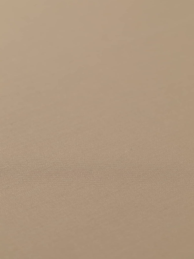 Flat, angled view of Golden Sand fabric, emphasizing its luxurious golden beige color and fine twill weave. The soft wool-poly blend ensures comfort and durability, making it a versatile choice for stylish, tailored pieces.